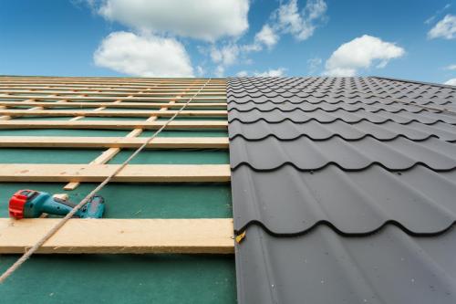 Roof with metal tile,screwdriver and roofing iron